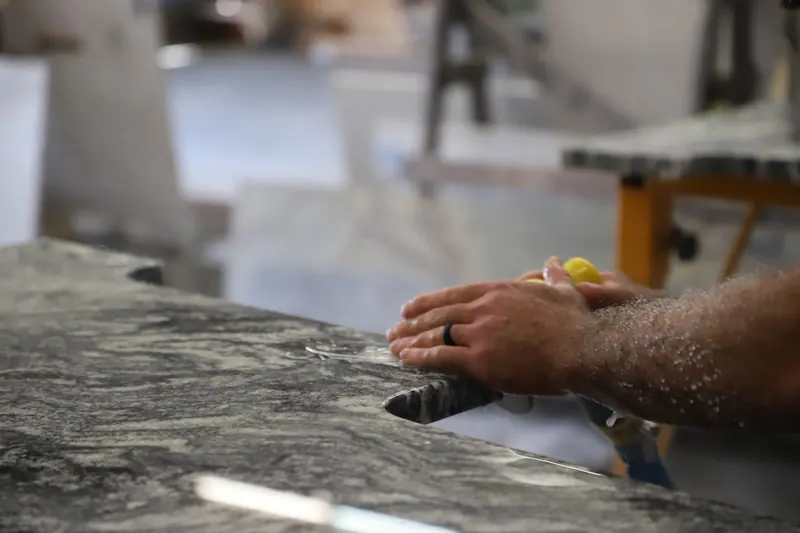 Oak Bay Rock & Tile craftsman finishing a stone surface