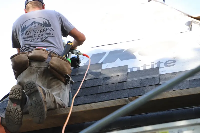 Ridge Runners roofer installing shingles on a roof